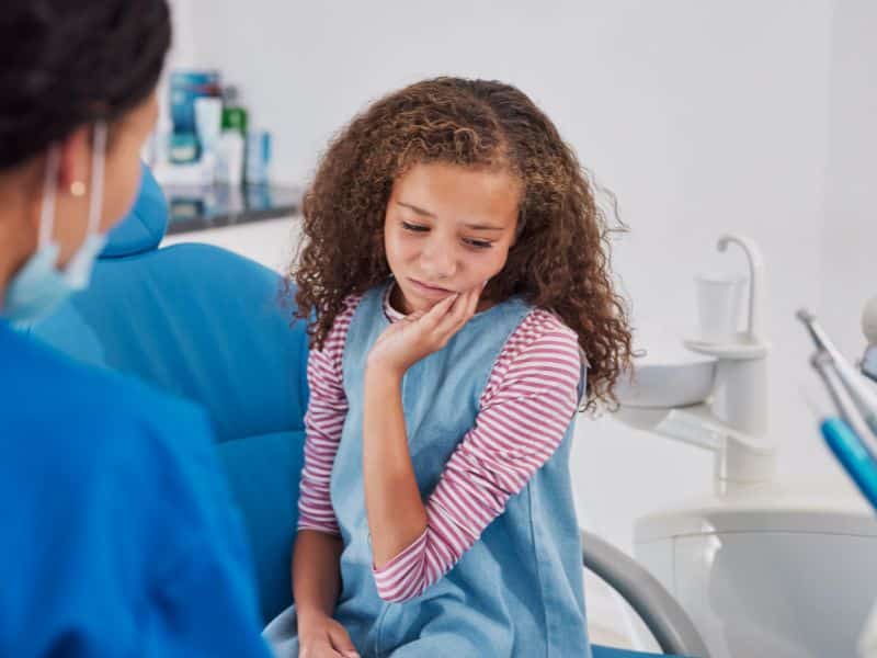 Emergency dental for kids — Dr. Sharma treating an urgent case as a kids emergency dentist at Smiles for Kids Peachtree Corners GA